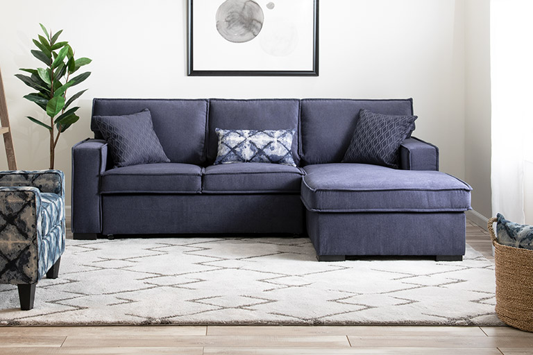 Blue two piece sectional sofa in living room.