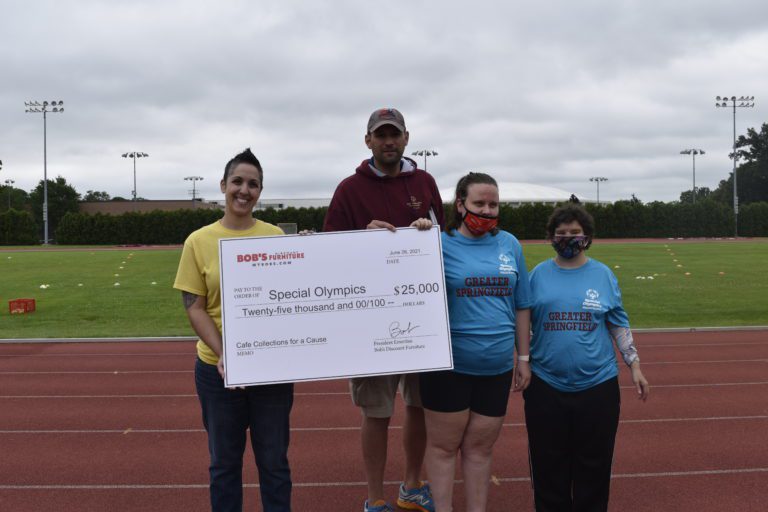 Melissa Ortins presents a check for $25,000 to Special Olympics from Bob's Discount Furniture.