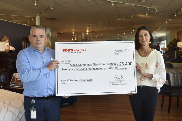 John Stowell, area sales manager with Bob's Discount Furniture, presents Liz Scott, co-executive director of Alex's Lemonade Stand Foundation with a check for $26,400.