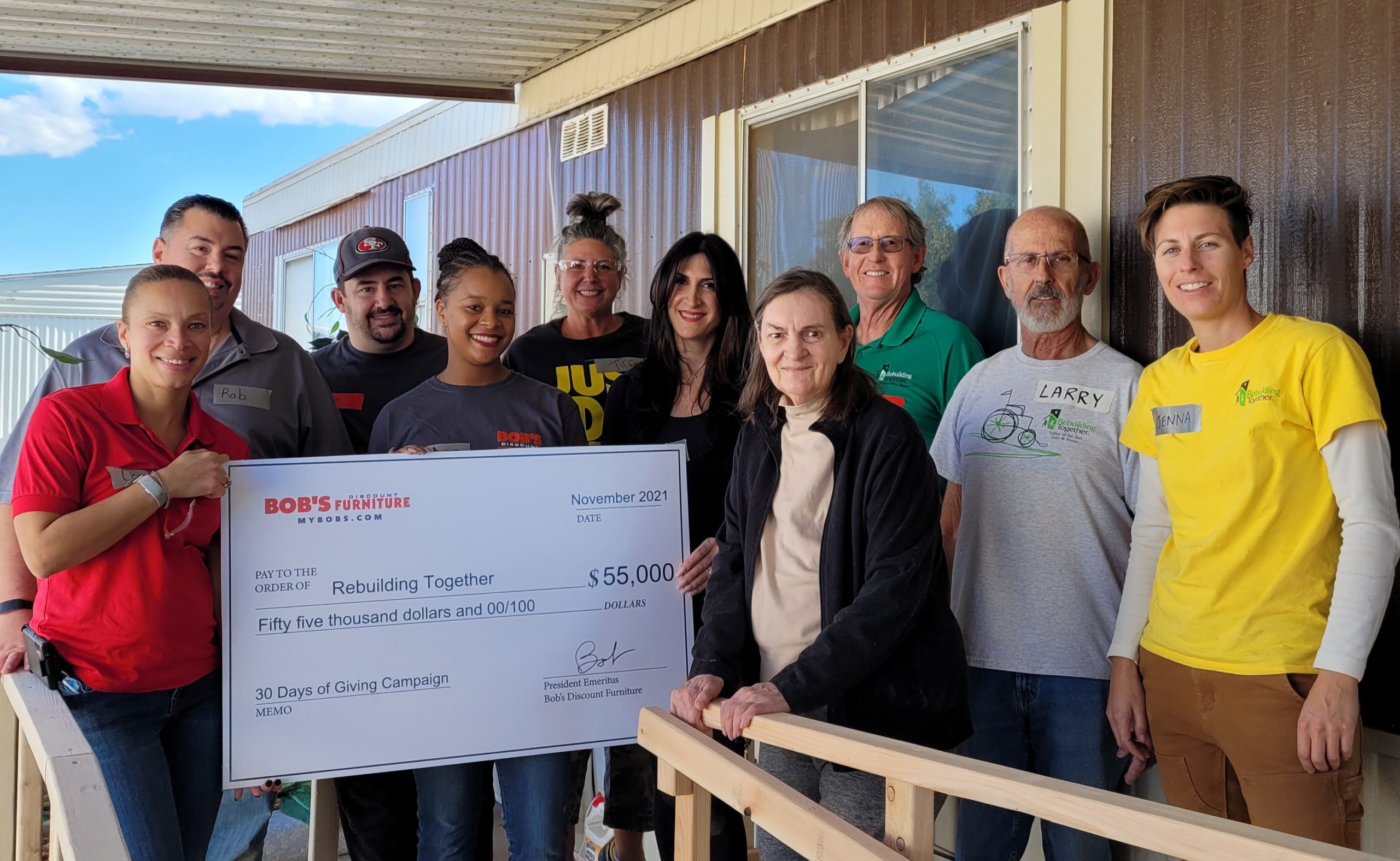 Bob's Discount Furniture presents Rebuilding Together with a check for $55,000