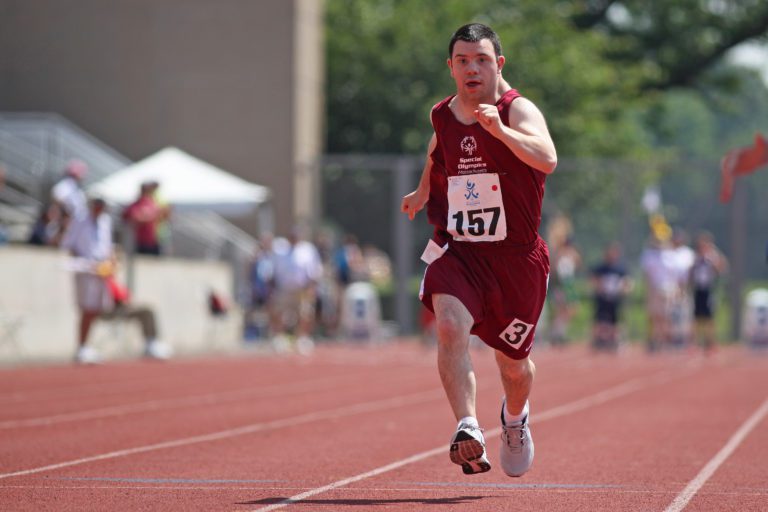 Athlete running on the track during an event for Special Olympics